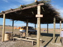 Shade structures with logs and willow.